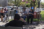 Mercedes Moreno, right, enjoys a free lunch that is distributed to people who need it in Southeast Portland's Sunnyside Park.