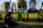 Mariana Rocha and Jackson Laparl look at a portrait of Joaquin Oliver, one of 17 students and staff killed at Marjory Stoneman Douglas High School, on Feb. 14, 2023.
