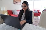 Alena Dasha Peethala, 18, shows OPB reporters an example of AI programs and policies on her computer while at her home in Beaverton on June 20, 2025.