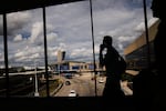 Passengers walk from a terminal at Philadelphia International Airport in Philadelphia, Tuesday, Oct. 7, 2025.