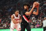 Portland Trail Blazers guard Shaedon Sharpe, right, looks to pass away from New York Knicks guard Miles McBride during the first half of an NBA basketball game, Sunday, Jan. 11, 2026, in Portland, Ore.