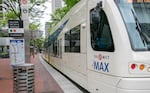 FILE - The MAX Light Rail waits for the green light in downtown Portland, Ore., June 26, 2025. Federal legislation now awaiting President Donald Trump's signature awards $100 million to bring light rail from Portland to Vancouver.