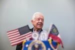 FILE - Former President Jimmy Carter stands behind his birthday cake during his 90th birthday celebration held at Georgia Southwestern University, Oct. 4, 2014, in Americus, Ga.