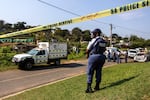 A police officer is seen at a scene of a mass shooting at a house party in KwaMakhutha township south of the city Durban, South Africa, Wednesday, Sept. 23, 2026.