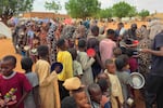 Women and children queue to receive free food being distributed in al-Mohayra camp for displaced people, near the city of el-Obeid on June 29, 2026.