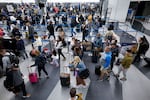 Travelers line up at the security checkpoint at O'Hare International Airport in Chicago on Friday ahead of the Thanksgiving holiday.