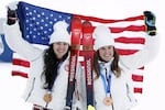 American skiers Jackie Wiles, left, and Paula Moltzan raise the U.S. flag after winning the bronze medal in the inaugural running of the Olympic women's Alpine team combined event