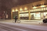 A bicyclist pulls into a New Seasons grocery store on Tacoma Street in Portland's Sellwood neighborhood during a snow storm on Tuesday, Jan. 10, 2017.