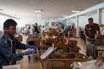 Volunteer shoppers fill grocery orders at the Edmonds Food Bank in Edmonds, Wash., Monday, Sept. 8, 2025.