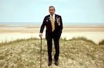 FILE - In this Wednesday, May 1, 2019 file photo, World War II and D-Day veteran Charles Norman Shay, from Maine, poses at the Charles Shay monument on Omaha Beach in Normandy, France. Instead of parades, remembrances, embraces and one last great hurrah for veteran soldiers who are mostly in their nineties to celebrate VE Day, it is instead a lockdown due to the coronavirus, COVID-19.