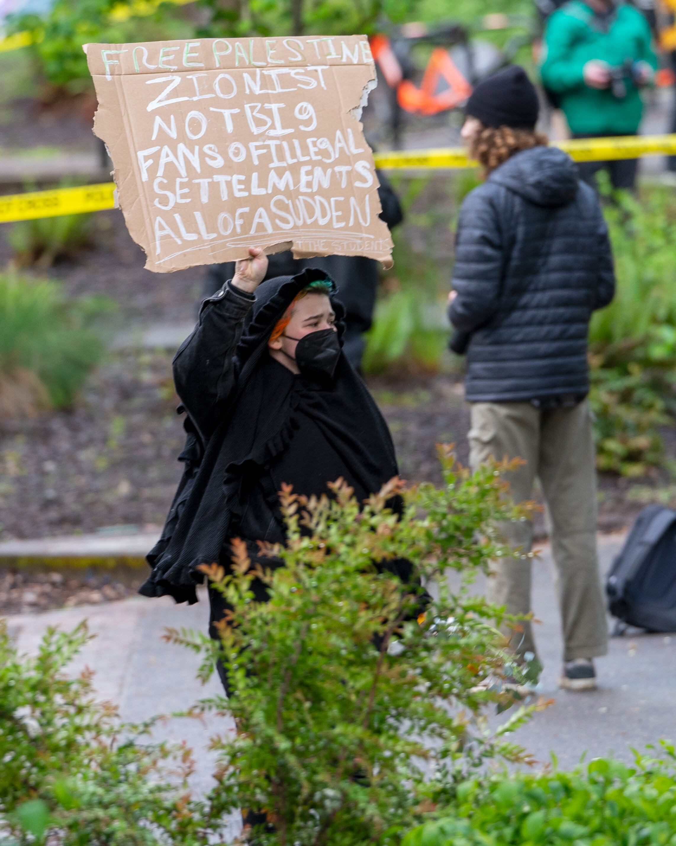 A person holds a sign outside Portland State University’s Branford Price Millar Library, May 2, 2024. People protesting Israel's role in the war in Gaza had occupied the library since Monday evening.