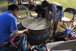 At a recent cultural gathering in northeastern Oregon, a Native American man and two youths set up a rawhide drum ahead of a pow-wow. To many Native people, the pounding of the drum signifies the connection they have with Mother Earth.