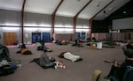 FILE-Guests settle in for the night while a volunteer plays guitar at Portland Central Church of the Nazarene in southeast Portland, Ore., Nov. 19, 2024. 