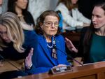 Sen. Dianne Feinstein, D-Calif., is flanked by aides as she returns to the Senate Judiciary Committee on May 11.