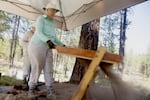 Jane Collier, a volunteer, sifts dust and sand through a screen. Any artifacts larger than 1/4 inch by 1/4 inch will get stuck in the screen, and catalogued.