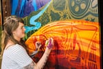 Liza Burns paints her mural, "Celebrate Oregon!"