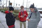 After their walk, John Hoac, Brandon Teeny, and Troy Abel take stock of the pollution they mapped on their walk around campus.