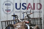 Signage for the US government's humanitarian agency USAID is seen on a cargo container beside a tricycle in Manila on Feb. 4. 