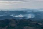 Slash piles burn after clearcutting near the Tillamook State Forest in western Oregon in October 2023.