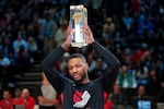 Damian Lillard of the Portland Trail Blazers celebrates after winning the three-point contest at the NBA basketball All-Star weekend Saturday, Feb. 18, 2023, in Salt Lake City.