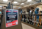 A sign encourages gun owners to get involved in pushing back on Washington’s ban on high-capacity magazines, seen at Gator’s Custom Guns in Kelso, Wash., April 16, 2024. Store owner Wally Wentz is at the center of a case determining the constitutionality of Washington’s high-capacity magazine ban, which went into effect in 2022. 