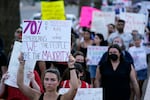 Protesters march around the Arizona Capitol in Phoenix after the Supreme Court decision to overturn Roe v. Wade. A new Arizona law banning abortions after 15 weeks of pregnancy takes effect Saturday, Sept. 24.