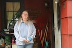 Brenda Palmer, 66, stands on her front porch on June 9, 2023. Palmer owns one of a dozen properties near Interstate 5 that could see significant construction when a new bridge is built over the Columbia River.