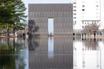 Visitors walk around the Reacting Pond at the Oklahoma City National Memorial & Museum in Oklahoma City on March 12, 2025.