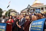 Texas state Senator Carol Alvarado, a Democrat, speaks in a crowd of other Democratic state lawmakers outside the Massachusetts State House on Wednesday, Aug. 6, 2025 in Boston.