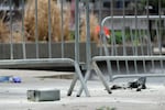 A metal can sits on the ground at the scene where a man lit himself on fire in a park outside Manhattan criminal court on Friday in New York.