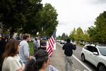 A man flashes what appears to be a white power hand gesture at cars near Skyview High School on Sept. 10, 2021. Vancouver School District recently received an injunction against "disruptive" protests from a Clark County Judge.