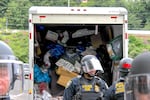 Federal officials were seen loading materials used to blockade the entrance to the Portland ICE building into a U-Haul truck Thursday, June 28, 2018, as they worked to reopen the entryway.