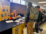 A representative from the International Union of Painters and Allied Trades talks to students at the David Douglas High School Career & Trades Fair on Nov. 15, 2023. Representatives from Oregon businesses say high school graduates should be able to communicate effectively and work in teams.