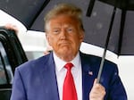 Former President Donald Trump walks to speak with reporters before boarding his plane at Ronald Reagan Washington National Airport, Aug. 3 in Arlington, Va.