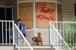 Noah Weibel and his dog, Cookie, return home on Monday as their family prepares for the arrival of Hurricane Milton in Port Richey, Florida.