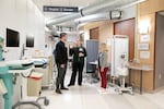 Left to right, Cory Woodyatt, R.N., Tonya Brockman, R.N., and Melinda Hartenstein, R.N., discuss protocols, March 24, 2020. The former OHSU auditorium space was converted to work as a routing area for people coming to the emergency department with respiratory symptoms that could be coronavirus-related. The area has intake, a waiting area that meets social distancing needs, triage and testing.