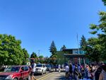 Ron Russell Middle School's 8th grade parade included several stations where students could pick up a gift bag and a T-shirt. Teachers and staff held signs and cheered on the graduates.