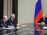 Russian President Vladimir Putin, right, chairs a meeting with top security officials Wednesday to discuss the Ukrainian military incursion in western Russia.