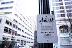 Signs prohibit people from blocking pedestrian traffic in front of the Columbia Sportswear Flagship Store in Downtown Portland.