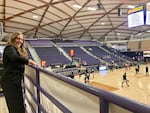 Claire Hogenson straightens a sign ahead of a Rip City Remix game in Portland, Ore., on Feb. 13. Hogenson is the first intern turned employee for the city’s inaugural minor league men’s basketball team, the Rip City Remix. The team plays at the University of Portland sports arena.