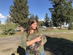 Julie Madison-Jamil and one of the chickens she raises.