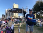 Anthony Diaz, Chief Operating Officer of Topeka Live, delivers food and drink to concert goers at the Moon Crush Pink Moon music festival.  