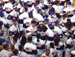 In a sea of U.S. athletes, flag bearer Katie Ledecky poses with her fellow American competitors during the closing ceremony of the Olympic Games.