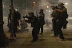 Police use tear gas and impact munitions to disperse protesters in downtown Portland during 4th of July demonstrations against systemic racism and police violence. 