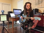 Josephine Relli plays guitar in the family basement, which serves as her classroom and music studio. She's a student at an online charter school, Oregon Connections Academy.