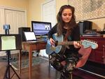 Josephine Relli plays guitar in the family basement, which serves as her classroom and music studio. She's a student at an online charter school, Oregon Connections Academy.