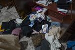 Clothing, photographs and other household items are scattered on the floor after Israeli authorities raid the East Jerusalem home of Ashraf Zeghayer following his release from prison.