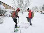 Sami Christensen (left) and Maddee Rubenson made their way down Northeast Dekum Street in Portland in skis on Wednesday, Jan. 11, 2017.