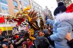 A dragon dance makes its way through a throng of people attending the annual Lunar New Year parade in New York City's Chinatown on Feb. 25, 2024.