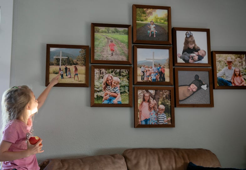 Jared and Amanda Smull's daughter Laelynn Smull, age six, points at a photo of the family on their land, July 31, 2024. Amanda Smull says their three kids are all involved in ranching, and regularly spend time with their parents on the land. 